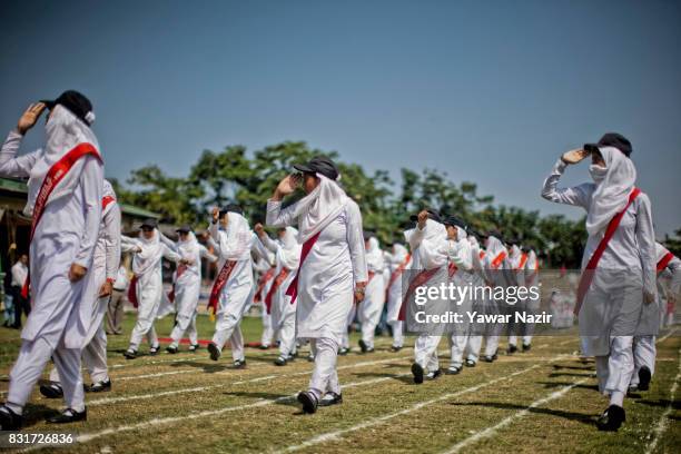 Kashmiri students salute at Bakshi Stadium, where the authorities hold the main function, during India's Independence Day celebrations on August 15,...