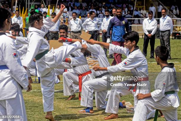 Students perform martial art skills at Bakshi Stadium, where the authorities hold the main function, during India's Independence Day celebrations on...
