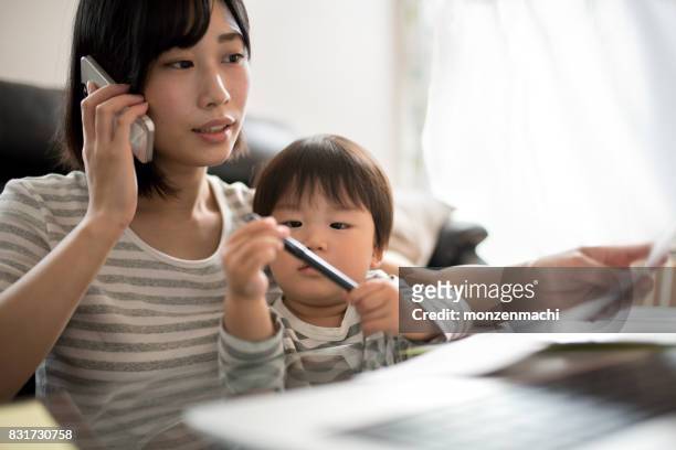 young mother working in house with her child
