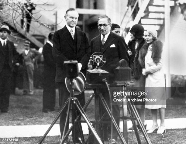 President Calvin Coolidge with Russian born film producer Louis B. Mayer on the MGM lot in Los Angeles, 19th February 1930. Actress Mary Pickford and...
