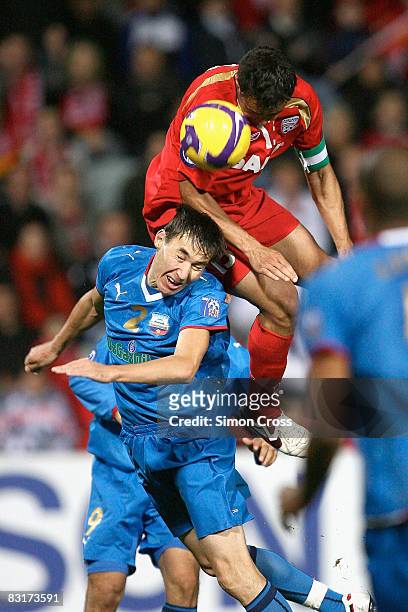 Travis Dodd of United jumps over Bakhtiyor Ashurmatov of Bunyodkor to set up Giuseppe Barbiero's goal during the AFC Champions League semi-final...
