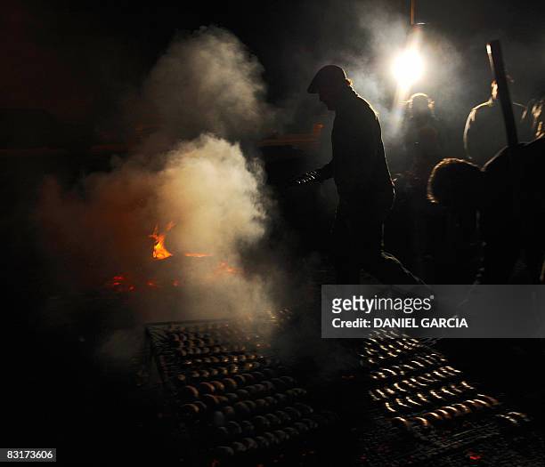 Peasant barbecues chorizo in an improvised grill in the side of the route 191, in the province of Buenos Aires on October 7 during the fifth day of a...