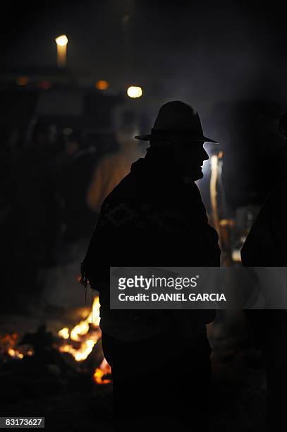 Peasants listen to a speaker during a meeting in the side of the route 191, in the province of Buenos Aires on October 7 during the fifth day of a...