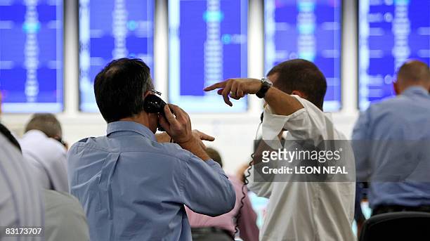 Brokers react to news of a 0.5% cut in the interest rate from the The Bank of England, on ICAP's dealing floor, in London, on October 8, 2008. The...