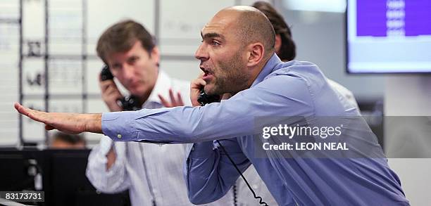 Brokers react to news of a 0.5% cut in the interest rate from the The Bank of England, on ICAP's dealing floor, in London, on October 8, 2008. The...