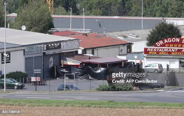 Picture taken in Sept-Sorts, 55km east of Paris, on August 15, 2017 shows a pizza restaurant covered by a black tarpaulin, a day after a car crashed...