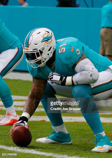 Mike Pouncey of the Miami Dolphins warms up before play against the Atlanta Falcons during a preseason game at Hard Rock Stadium on August 10, 2017...