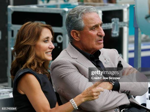 Arthur Blank, owner of the Atlanta Falcons sits with his wife Angela Macuga before the start of play between the Falcons and the Miami Dolphins...