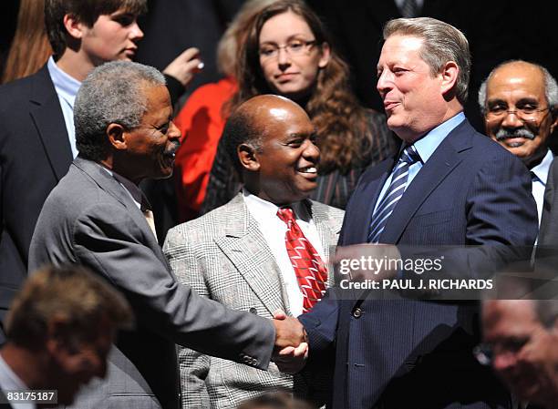 Former US Vice-President Al Gore shakes hands with former CNN anchor Bernard Shaw prior to the Town Hall Presidential Debate at Belmont University's...