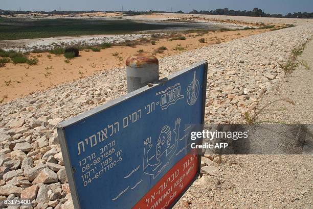 Sign warns from drowning in the Nahalei Menashea percolation reservoir next to the Israeli coastal city of Cesarea, on September 9, 2008. The...