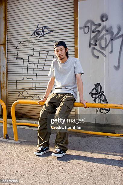 japanese man on the street - sitting ストックフォトと画像