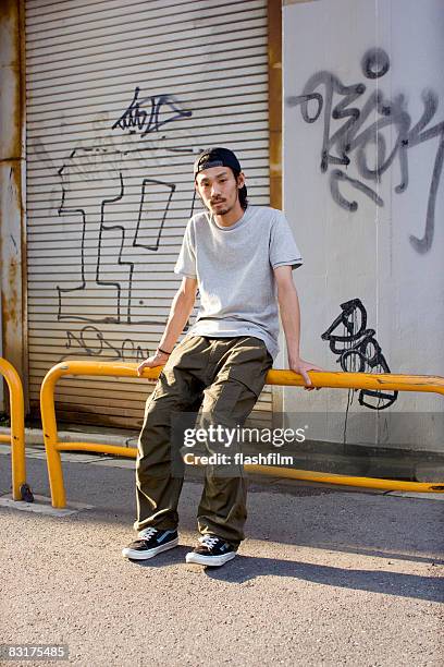 japanese man on the street - asian man seated stock pictures, royalty-free photos & images