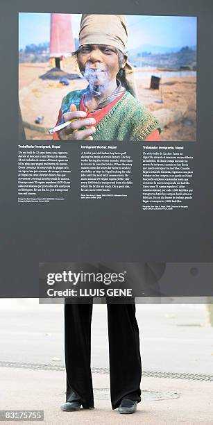 Woman looks at a photo exhibit of the Himalayan mountains on October 8, 2008 at the World Conservation Congress in Barcelona. The photos, taken in...