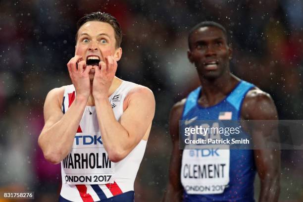 Karsten Warholm of Norway and Kerron Clement of the United States react after crossing the finish line in the Men's 400 metres hurdles during day six...
