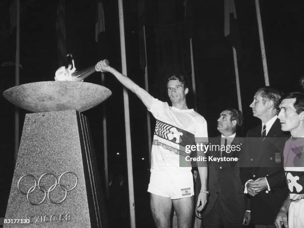 The Olympic torch arrives in Madrid, on its way to the opening ceremony of the Mexico Olympics, 5th September 1968. Spanish politician Carlos Arias...