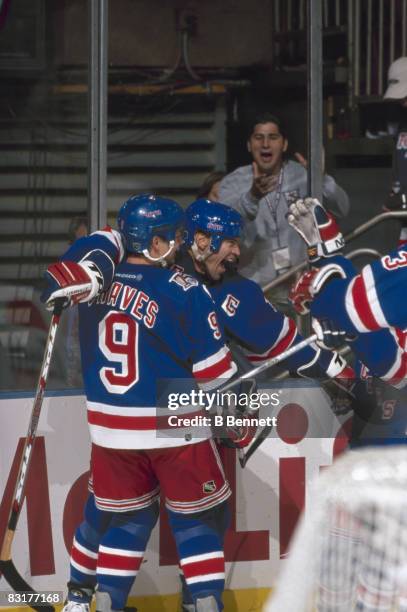 Canadian ice hockey player Mark Messier of the New York Rangers celebrates with teammate Adam Graves during the 2000-2001 season opener at Madison...