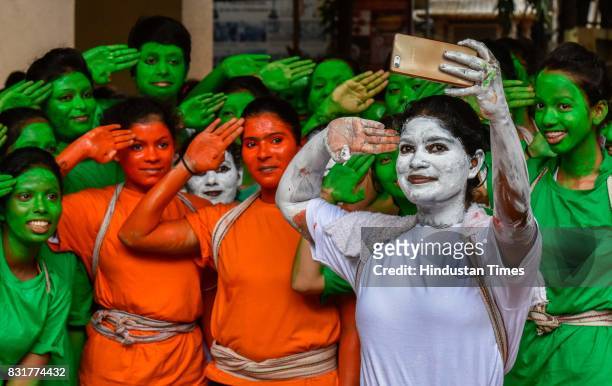 College students take selfie as they get ready for a cultural event in the run up to the Dahi Handi celebrations of 'Janmashtami', which marks the...