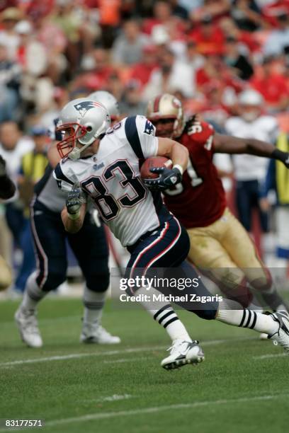 Wide receiver Wes Welker of the New England Patriots runs with the ball against the San Francisco 49ers during the NFL game on Bill Walsh Field at...