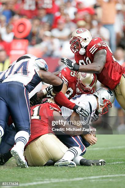 Defensive end Ray McDonald and linebacker Tully Banta-Cain of the San Francisco 49ers sack quarterback Matt Cassel of the New England Patriots during...