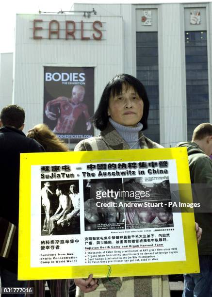 One of the European Friends of the Falun Gong Hua Zhao demonstrates outside the opening of "Bodies...The Exhibition" at Earls Court Exhibition...