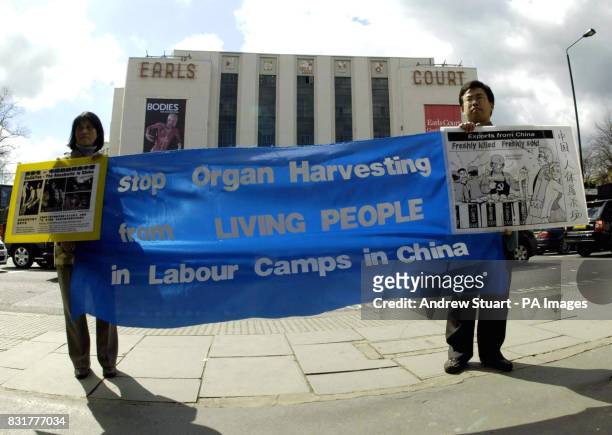 Two of the European Friends of the Falun Gong Hua Zhao demonstrate outside the opening of "Bodies...The Exhibition" at Earls Court Exhibition Centre,...