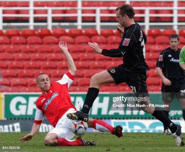 Swindon's Andy Nicholas in action with MK Dons Aaron Wilbraham during the Coca-Cola League One match at The County Ground, Swindon.