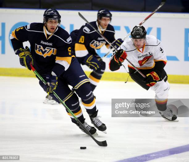 Mikko Luoooma of HV71 Jonkoping fight for the puck with Simon Gamache of Bern during the IIHF Champions Hockey League match between HV71 Joenkoeping...