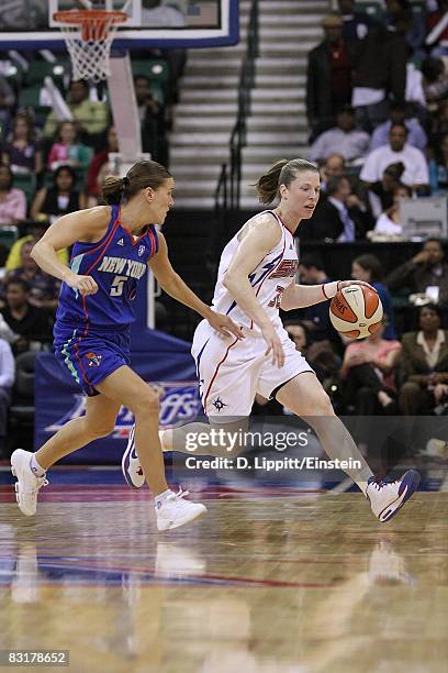 Katie Smith of the Detroit Shock drives the ball against Erin Thorn of the New York Liberty in Game Three of the Eastern Conference Finals during the...