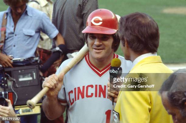 View of American baseball player Pete Rose, of the Cincinatti Reds, as he is interviewed by sports broadcaster Frank Gifford in the dugout before a...