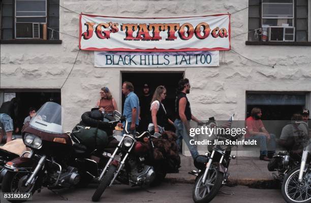 50th Anniversary of the World Famous Sturgis Motorcycle Rally. Motorcycles parked in front of JG's Tattoo Co. In Sturgis, South Dakota on August 6,...