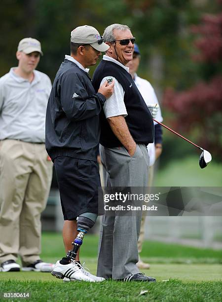 David Cook, U.S. Army, left, and playing partner Fuzzy Zoeller exchange a few laughs on the first tee during the Pro-Am round for the Constellation...