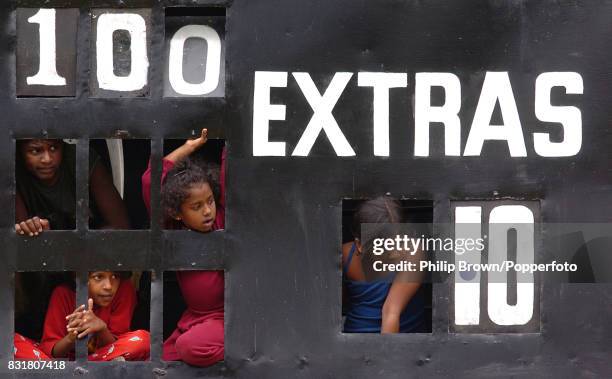 Children in the scoreboard watch as Tillakaratne Dilshan of Sri Lanka leaves the field after being dismissed for 100 runs in the 2nd Test match...