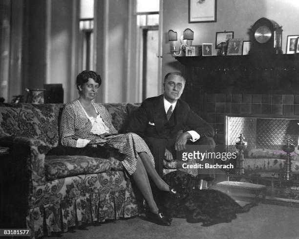 Gov. Franklin Roosevelt sitting beside wife Eleanor w. Their dog at their feet in Executive Mansion. New York, 1929.