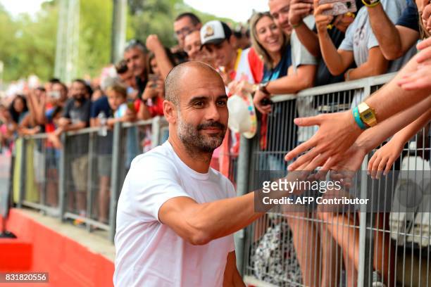 Manchester City's Spanish coach Pep Guardiola cheers Girona supporters before the annual 41st Costa Brava Trophy friendly football match betwen...