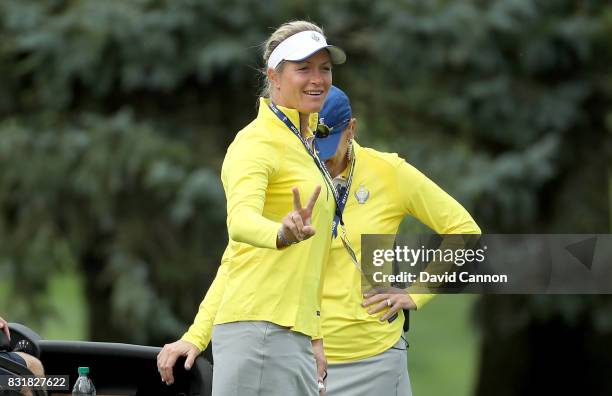 Suzann Pettersen of Norway and the European Team makes a victory gesture beside Annika Sorenstam of Sweden the European team captain during practice...