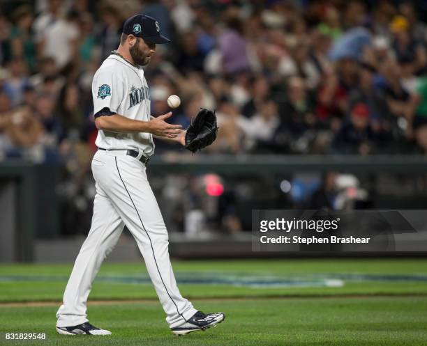 Relief pitcher Tony Zych of the Seattle Mariners tosses the ball as he walks back to the pitcher's mound during a game against the Los Angeles Angels...