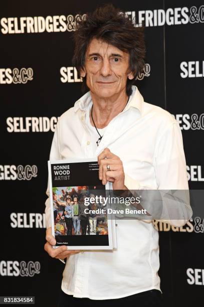 Ronnie Wood poses with a copy of his new book 'Ronnie Wood: Artist' at Selfridges on August 15, 2017 in London, England.