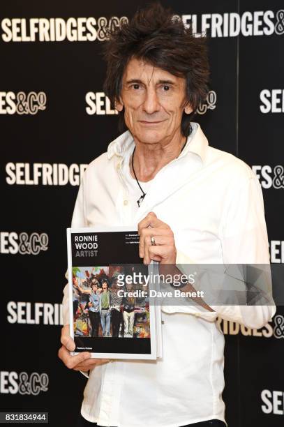 Ronnie Wood poses with a copy of his new book 'Ronnie Wood: Artist' at Selfridges on August 15, 2017 in London, England.