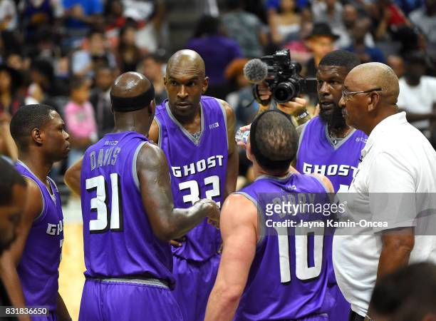 George Gervin, head coach of Ghost Ballers, huddles for a time out with Ivan Johnson, Joe Smith, Marcus Banks, Ricky Davis and Mike Bibby during the...