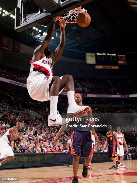 Greg Oden of the Portland Trail Blazers throws down a dunk infront of Al Harrington of the Golden State Warriors during a game on October 8, 2008 at...