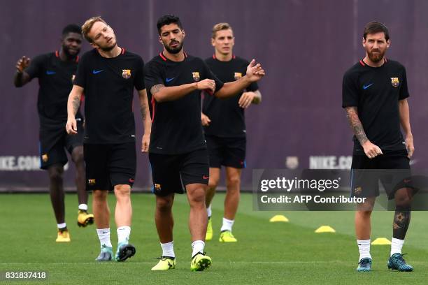 Barcelona's Argentinian forward Lionel Messi , Barcelona's Uruguayan forward Luis Suarez and Barcelona's Croatian midfielder Ivan Rakitic take part...