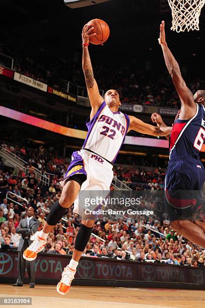 Matt Barnes of the Phoenix Suns drives against Mario West of the Atlanta Hawks in an NBA game played on October 8 at U.S. Airways Center in Phoenix,...