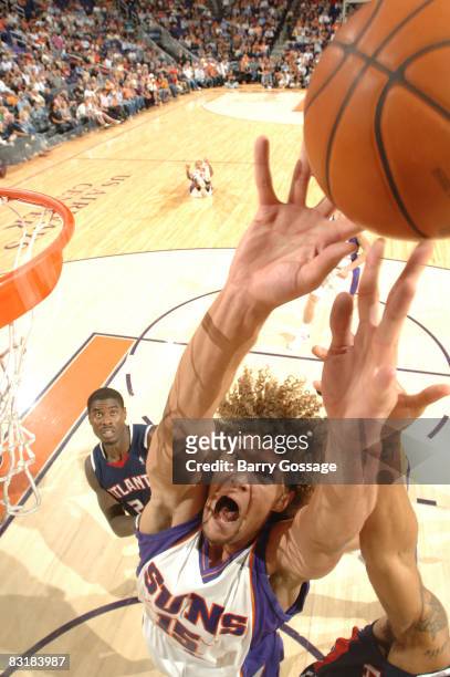 Robin Lopez of the Phoenix Suns reaches for a rebound against the Atlanta Hawks in an NBA game played on October 8 at U.S. Airways Center in Phoenix,...