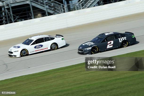 David Ragan, driver of the Front Row Motorsports Ford, and Brad Keslowski, driver of the Miller Lite Ford, drive during testing for the Monster...