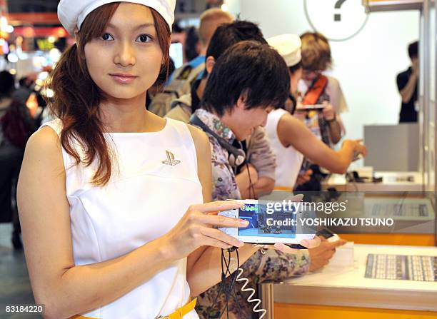 Model displays Sony Computer Entertainment's new portable video game console PSP-3000, equipped with a high contrast LCD display at the Tokyo Game...