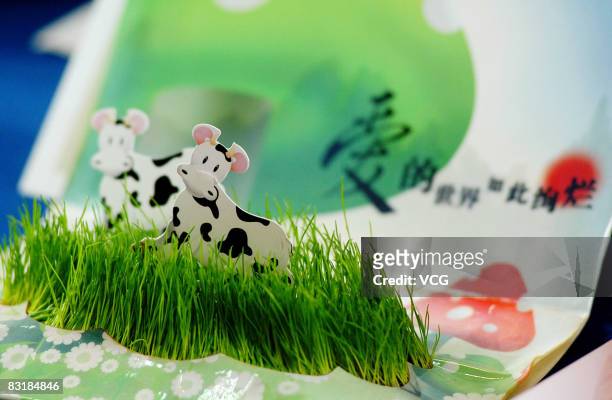 Post office worker shows off a greeting card which can grow grass, on October 8, 2008 at a post office central China's Chongqing Municipality. The...