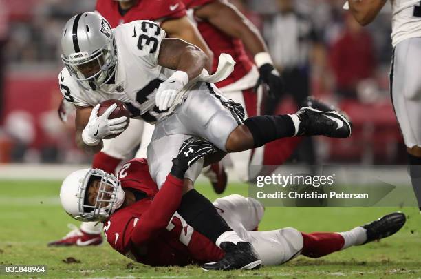 Running back DeAndre Washington of the Oakland Raiders rushes the football against cornerback Justin Bethel of the Arizona Cardinals during the NFL...