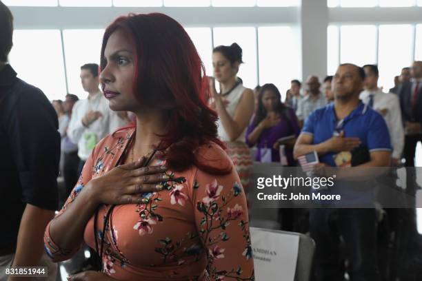 Immigrants listen to the National Anthem at a naturalization ceremony held in the observatory of the One World Trade Center on August 15, 2017 in New...