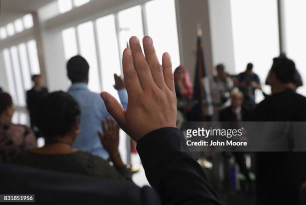 Immigrants take the oath of allegiance to the United States at a naturalization ceremony held in the observatory of the One World Trade Center on...