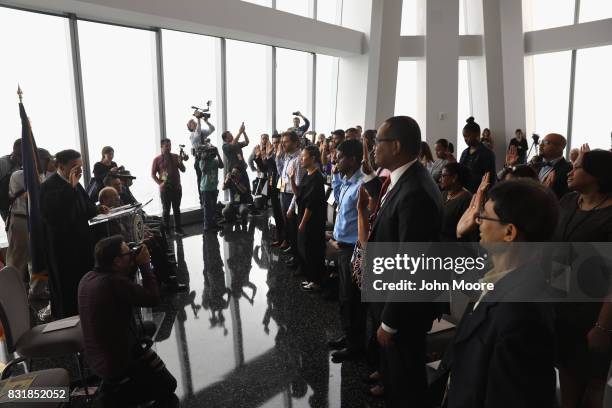 Immigrants take the oath of allegiance to the United States at a naturalization ceremony held in the observatory of the One World Trade Center on...